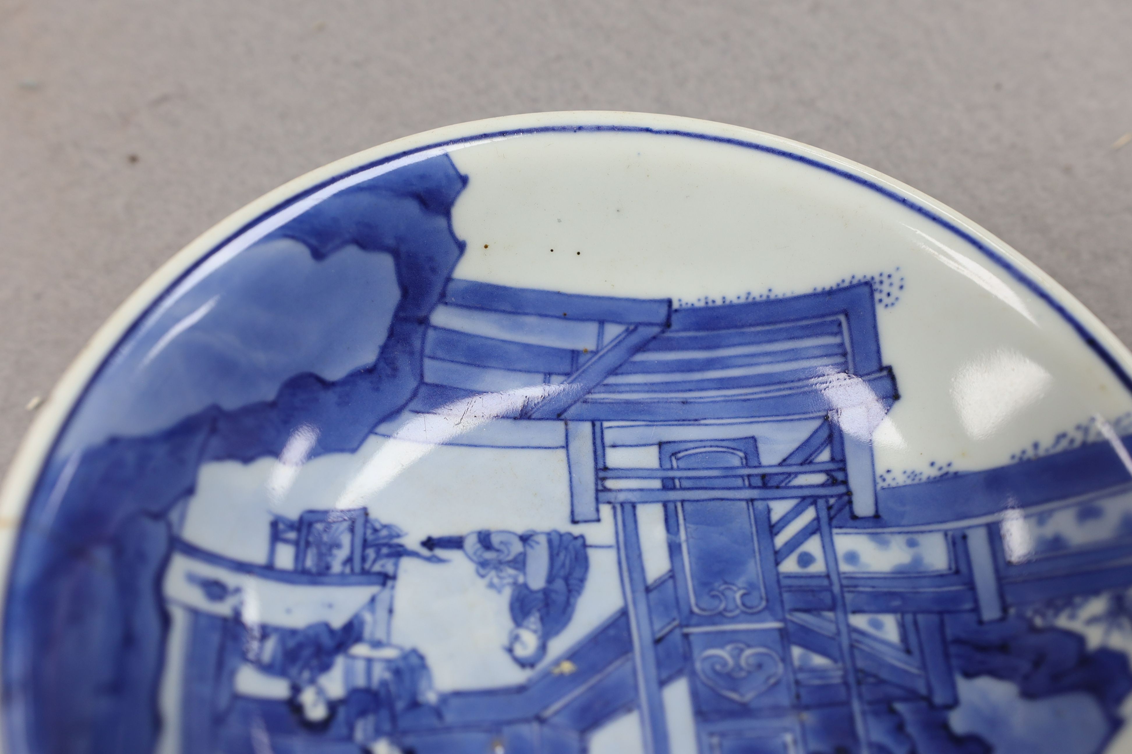 NB BOTH WITH HAIRLINE CRACKS A pair of Chinese blue and white small dishes, Kangxi six character marks and of the period (1662-1722), 15.7cm and 15.8cm diameter, foot later pierced, hairline cracks